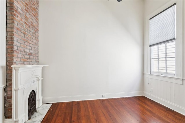 3119 Dauphine St, New Orleans, LA 70117 - unfurnished living room with dark wood finished floors and a fireplace with flush hearth