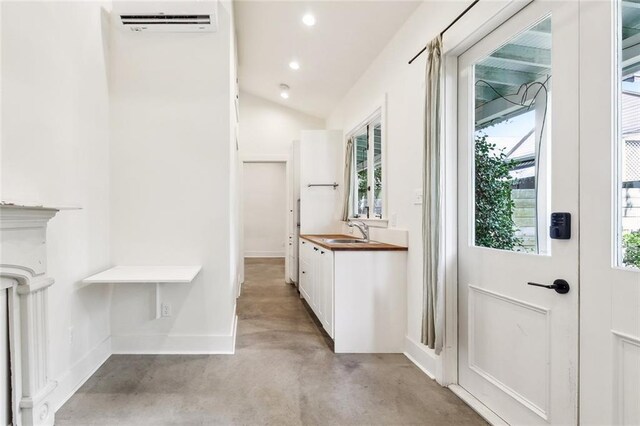 3119 Dauphine St, New Orleans, LA 70117 - mudroom featuring concrete flooring, a wall mounted air conditioner, recessed lighting, and vaulted ceiling