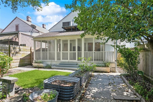 3119 Dauphine St, New Orleans, LA 70117 - back of house featuring a sunroom and a fenced backyard