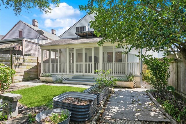 3119 Dauphine St, New Orleans, LA 70117 - back of house featuring a sunroom and a fenced backyard