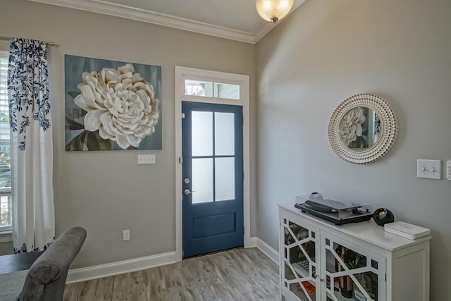 61113 Jade St, Lacombe, LA 70445 - entryway with crown molding, baseboards, light wood-style flooring, and healthy amount of natural light