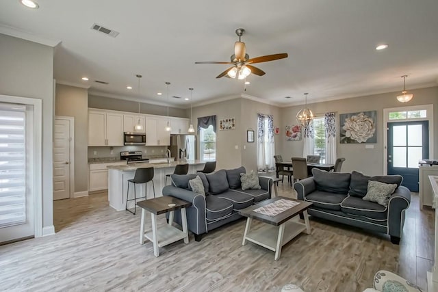 61113 Jade St, Lacombe, LA 70445 - living room with ornamental molding, light wood-style flooring, healthy amount of natural light, recessed lighting, and ceiling fan