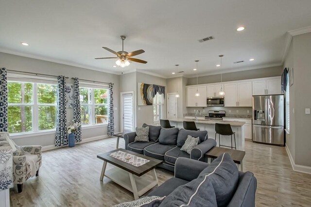 61113 Jade St, Lacombe, LA 70445 - living area with ornamental molding, baseboards, light wood-type flooring, recessed lighting, and ceiling fan