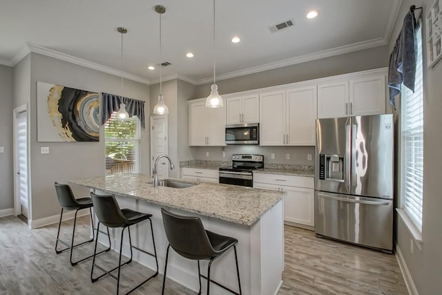 61113 Jade St, Lacombe, LA 70445 - kitchen with appliances with stainless steel finishes, a sink, plenty of natural light, light wood-type flooring, and crown molding