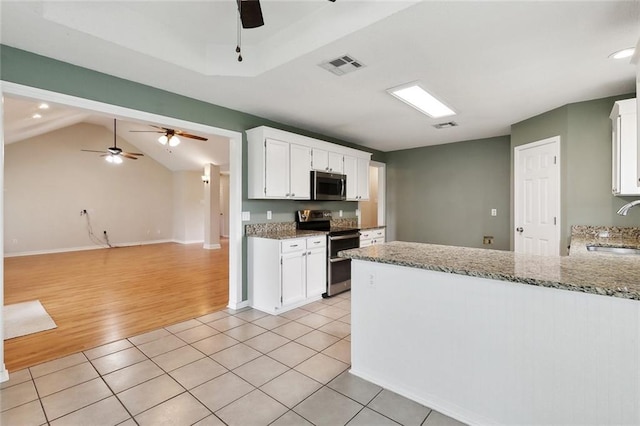4740 Red Oak Dr, Marrero, LA 70072 - kitchen with stainless steel appliances, a ceiling fan, a sink, light wood finished floors, and light stone countertops