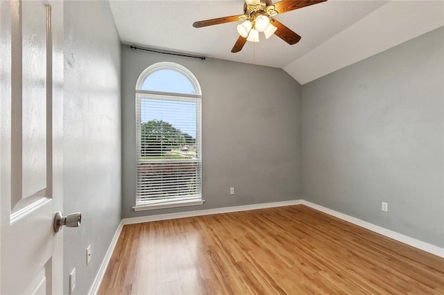 4740 Red Oak Dr, Marrero, LA 70072 - empty room with a ceiling fan, wood finished floors, baseboards, and vaulted ceiling