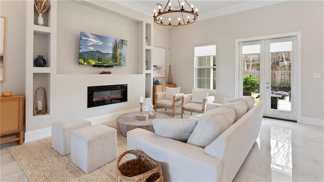 811 Rosa Ave, Metairie, LA 70005 - living area with a chandelier, a glass covered fireplace, baseboards, built in features, and ornamental molding