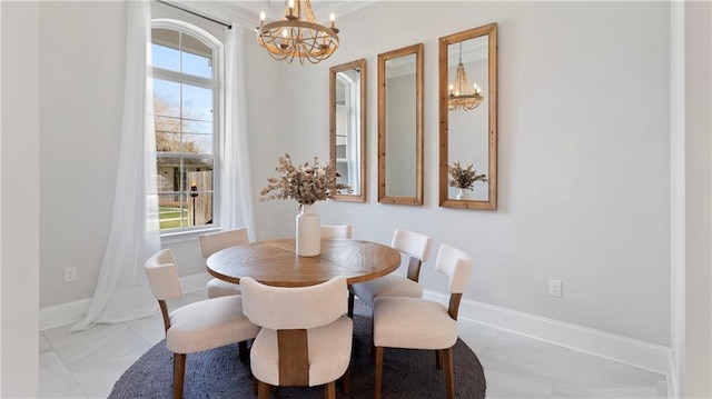811 Rosa Ave, Metairie, LA 70005 - dining room featuring a chandelier, healthy amount of natural light, and baseboards
