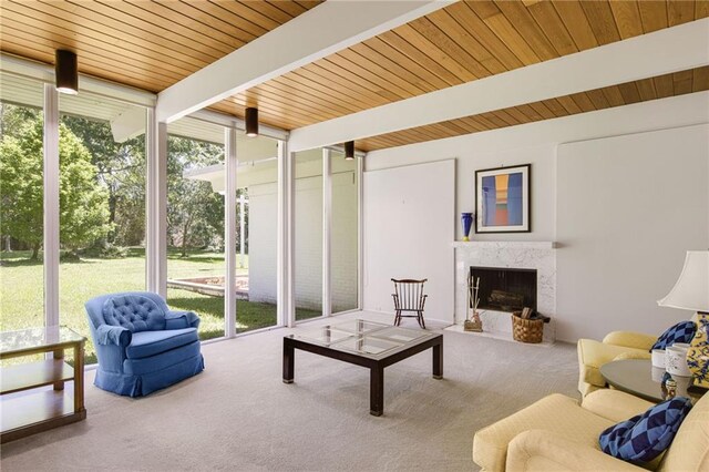 1450 Pine Tree Rd, Opelousas, LA 70570 - living room with expansive windows, carpet flooring, a fireplace, and wood ceiling with exposed beams