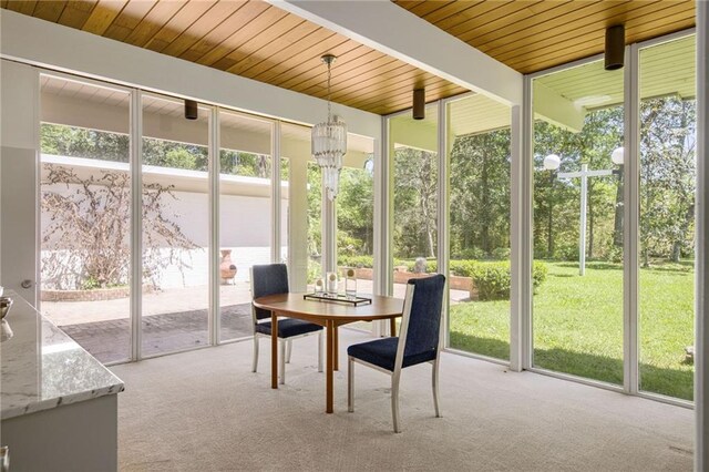 1450 Pine Tree Rd, Opelousas, LA 70570 - sunroom featuring healthy amount of natural light, beamed ceiling, outdoor dining space, and a chandelier