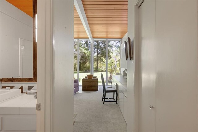 1450 Pine Tree Rd, Opelousas, LA 70570 - corridor with expansive windows, carpet flooring, and wood ceiling