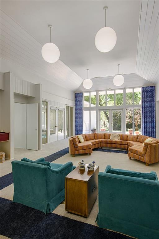 1450 Pine Tree Rd, Opelousas, LA 70570 - living room featuring plenty of natural light, lofted ceiling, and light colored carpet