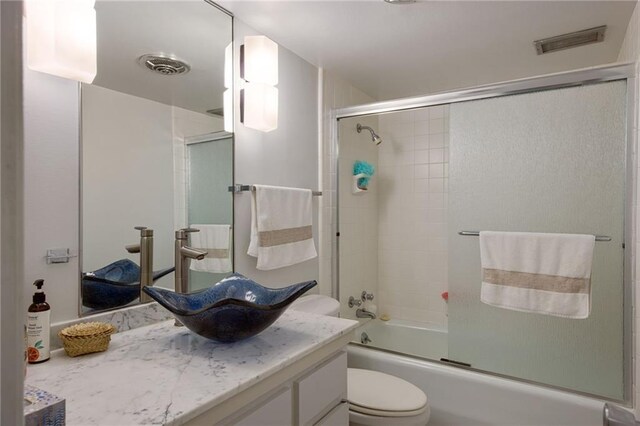 1450 Pine Tree Rd, Opelousas, LA 70570 - full bathroom featuring toilet, shower / bath combination with glass door, and vanity