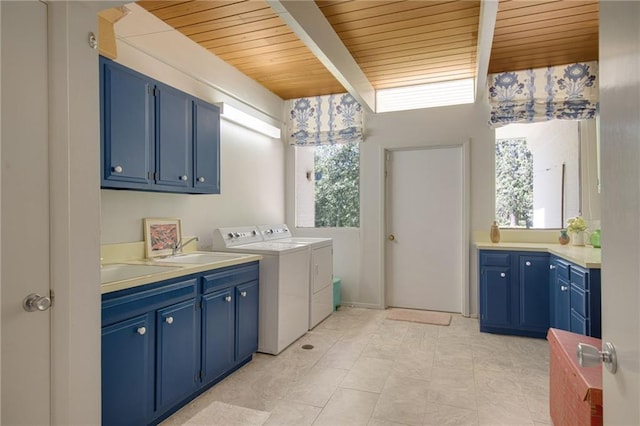 1450 Pine Tree Rd, Opelousas, LA 70570 - laundry area featuring washer and clothes dryer, cabinet space, healthy amount of natural light, and wood ceiling