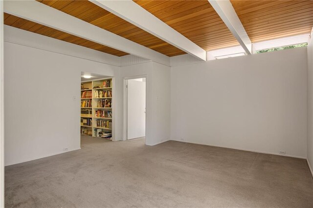 1450 Pine Tree Rd, Opelousas, LA 70570 - carpeted empty room with wooden ceiling with exposed beams