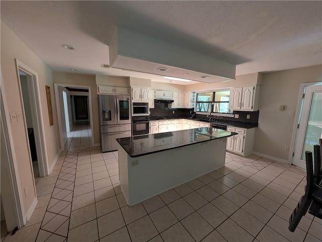 608 Eagle Dr, Slidell, LA 70461 - kitchen with black appliances, light tile patterned flooring, a sink, white cabinets, and recessed lighting