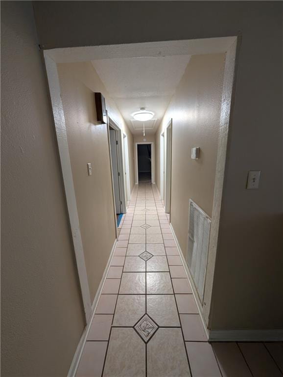 608 Eagle Dr, Slidell, LA 70461 - hall featuring attic access, light tile patterned floors, and baseboards