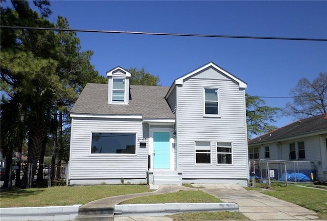 2147 Carnot St, New Orleans, LA 70122 - traditional-style house with entry steps, a front yard, and roof with shingles