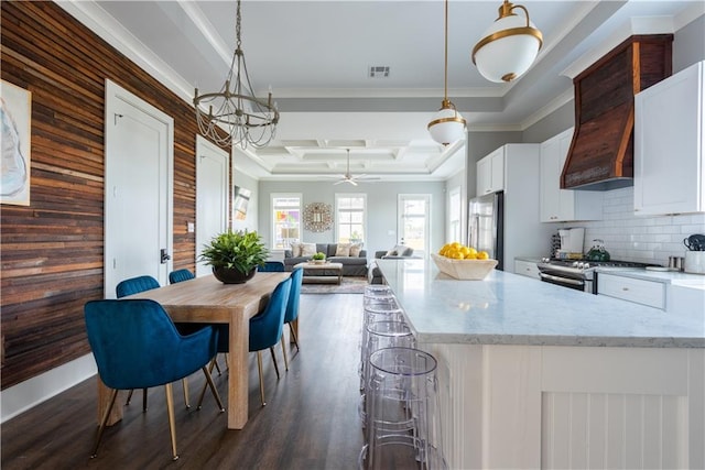415 N Dupre St, New Orleans, LA 70119 - kitchen featuring stainless steel appliances, ornamental molding, dark wood finished floors, white cabinets, and a ceiling fan