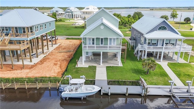 4027 Borneo St, Bay Saint Louis, MS 39520 - rear view of house featuring a patio, a water view, a carport, and a yard