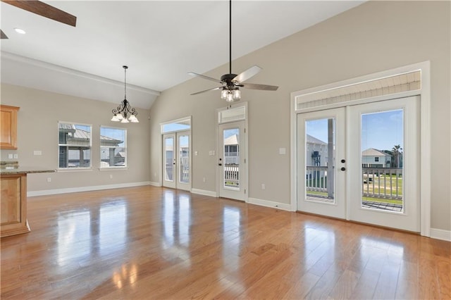 4027 Borneo St, Bay Saint Louis, MS 39520 - unfurnished living room featuring french doors, lofted ceiling, light wood-type flooring, a ceiling fan, and baseboards