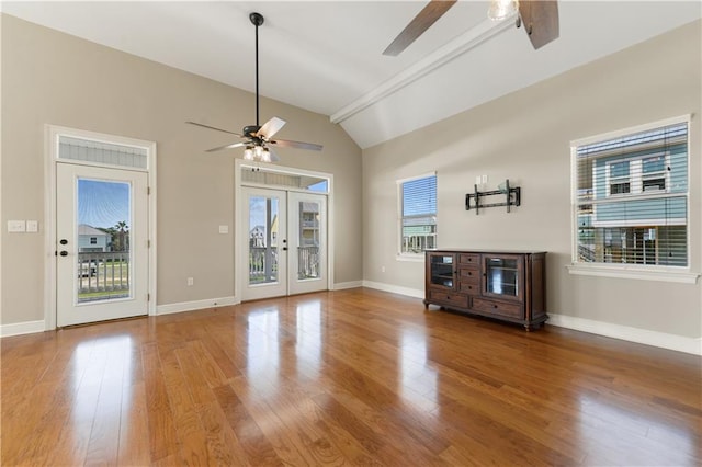 4027 Borneo St, Bay Saint Louis, MS 39520 - unfurnished living room featuring a ceiling fan, lofted ceiling, french doors, wood finished floors, and baseboards