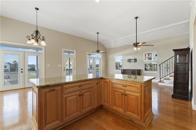 4027 Borneo St, Bay Saint Louis, MS 39520 - kitchen with french doors, light wood-style floors, healthy amount of natural light, and vaulted ceiling