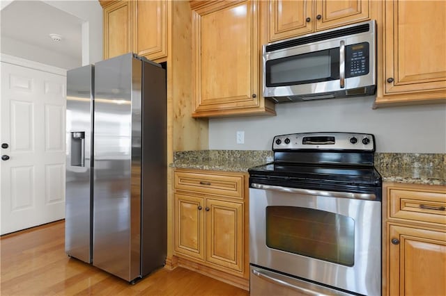 4027 Borneo St, Bay Saint Louis, MS 39520 - kitchen featuring stainless steel appliances, light wood-style flooring, and stone counters