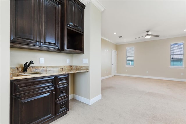 4027 Borneo St, Bay Saint Louis, MS 39520 - kitchen with a sink, ornamental molding, light carpet, baseboards, and a ceiling fan