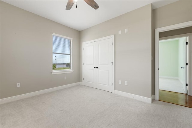 4027 Borneo St, Bay Saint Louis, MS 39520 - unfurnished bedroom featuring light colored carpet, baseboards, a ceiling fan, and a closet