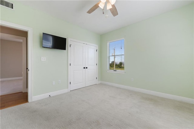 4027 Borneo St, Bay Saint Louis, MS 39520 - unfurnished bedroom featuring carpet, baseboards, a closet, and ceiling fan