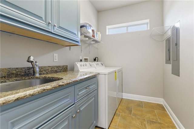 4027 Borneo St, Bay Saint Louis, MS 39520 - laundry area with separate washer and dryer, baseboards, cabinet space, and light stone finish flooring