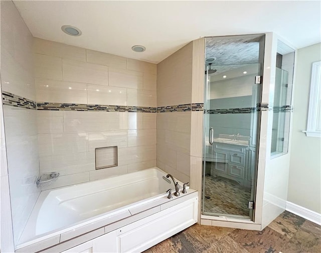 4508 Hessmer Ave, Metairie, LA 70002 - full bathroom featuring a bath, a stall shower, and baseboards