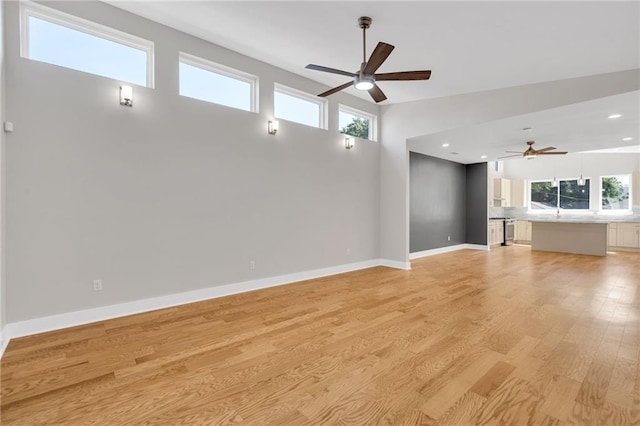 6100 Duplessis St, New Orleans, LA 70122 - unfurnished living room featuring a ceiling fan, light wood-style floors, baseboards, and recessed lighting