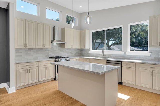 6100 Duplessis St, New Orleans, LA 70122 - kitchen featuring wall chimney range hood, stainless steel appliances, plenty of natural light, light stone counters, and recessed lighting