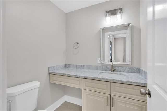 6100 Duplessis St, New Orleans, LA 70122 - bathroom featuring toilet, vanity, and baseboards