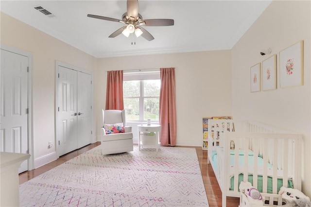 8 Ani St, New Orleans, LA 70124 - bedroom with wood finished floors, baseboards, a crib, ornamental molding, and a ceiling fan