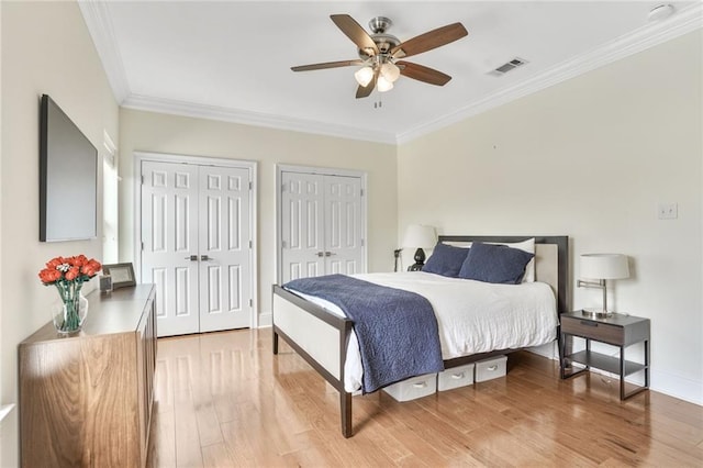 8 Ani St, New Orleans, LA 70124 - bedroom with crown molding, multiple closets, light wood finished floors, baseboards, and a ceiling fan