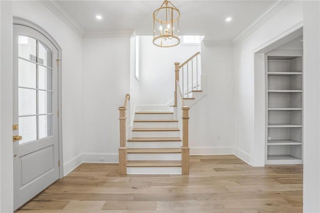 7331 Onyx St, New Orleans, LA 70124 - entryway featuring a chandelier, stairs, wood finished floors, baseboards, and ornamental molding
