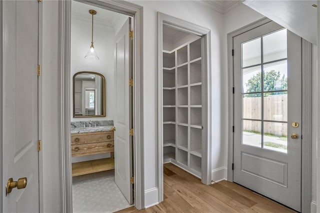 7331 Onyx St, New Orleans, LA 70124 - interior space featuring crown molding, light wood-style flooring, and a sink