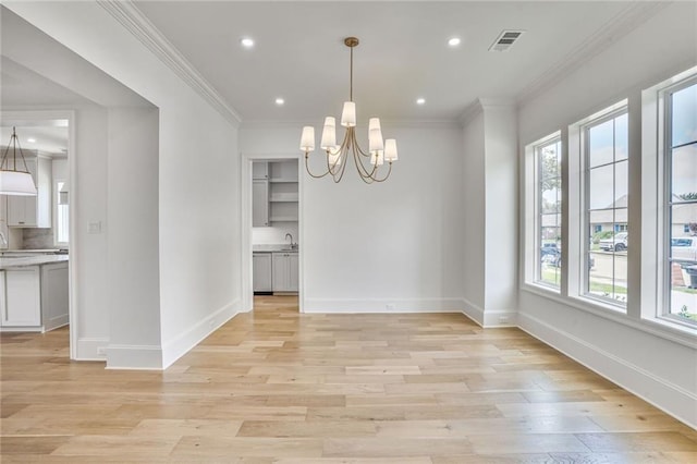 7331 Onyx St, New Orleans, LA 70124 - unfurnished dining area with a chandelier, light wood-style flooring, baseboards, recessed lighting, and a sink