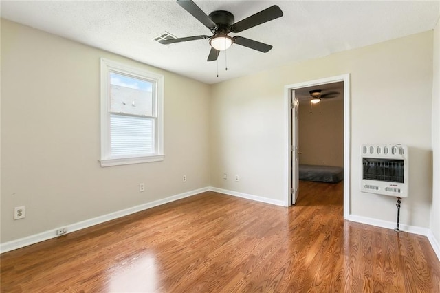 3309 4th St, New Orleans, LA 70125 - empty room featuring heating unit, ceiling fan, wood finished floors, and baseboards