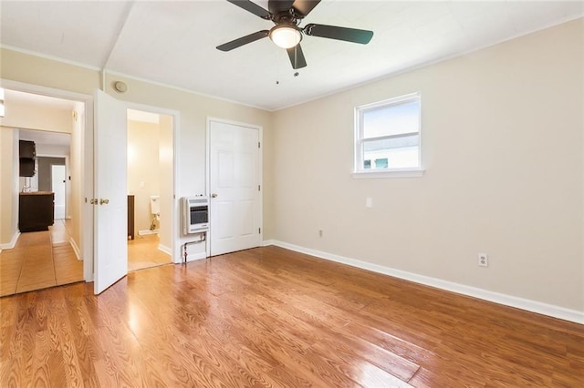 3309 4th St, New Orleans, LA 70125 - unfurnished bedroom featuring heating unit, ornamental molding, light wood finished floors, baseboards, and ensuite bath