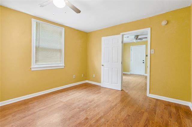 3309 4th St, New Orleans, LA 70125 - unfurnished room with ceiling fan, baseboards, light wood-style floors, and a smoke detector