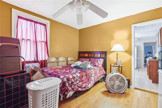 3309 4th St, New Orleans, LA 70125 - bedroom featuring wood finished floors, a ceiling fan, and baseboards