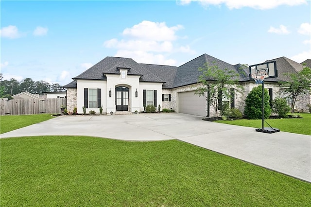 1112 Safflower Ct, Madisonville, LA 70447 - french country home with roof with shingles, an attached garage, driveway, and stone siding