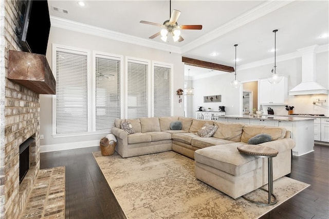 1112 Safflower Ct, Madisonville, LA 70447 - living room featuring a ceiling fan, dark wood-style flooring, recessed lighting, a fireplace, and crown molding