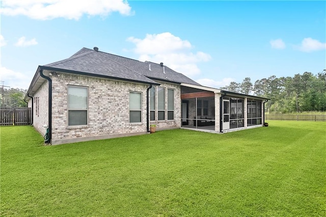 1112 Safflower Ct, Madisonville, LA 70447 - rear view of house with a sunroom, brick siding, and roof with shingles