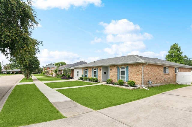9 Osborne Ave, Kenner, LA 70065 - ranch-style home featuring brick siding, a front lawn, and concrete driveway