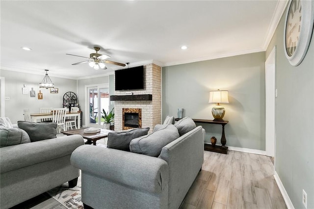 9 Osborne Ave, Kenner, LA 70065 - living area with ceiling fan, baseboards, light wood-style floors, a brick fireplace, and ornamental molding